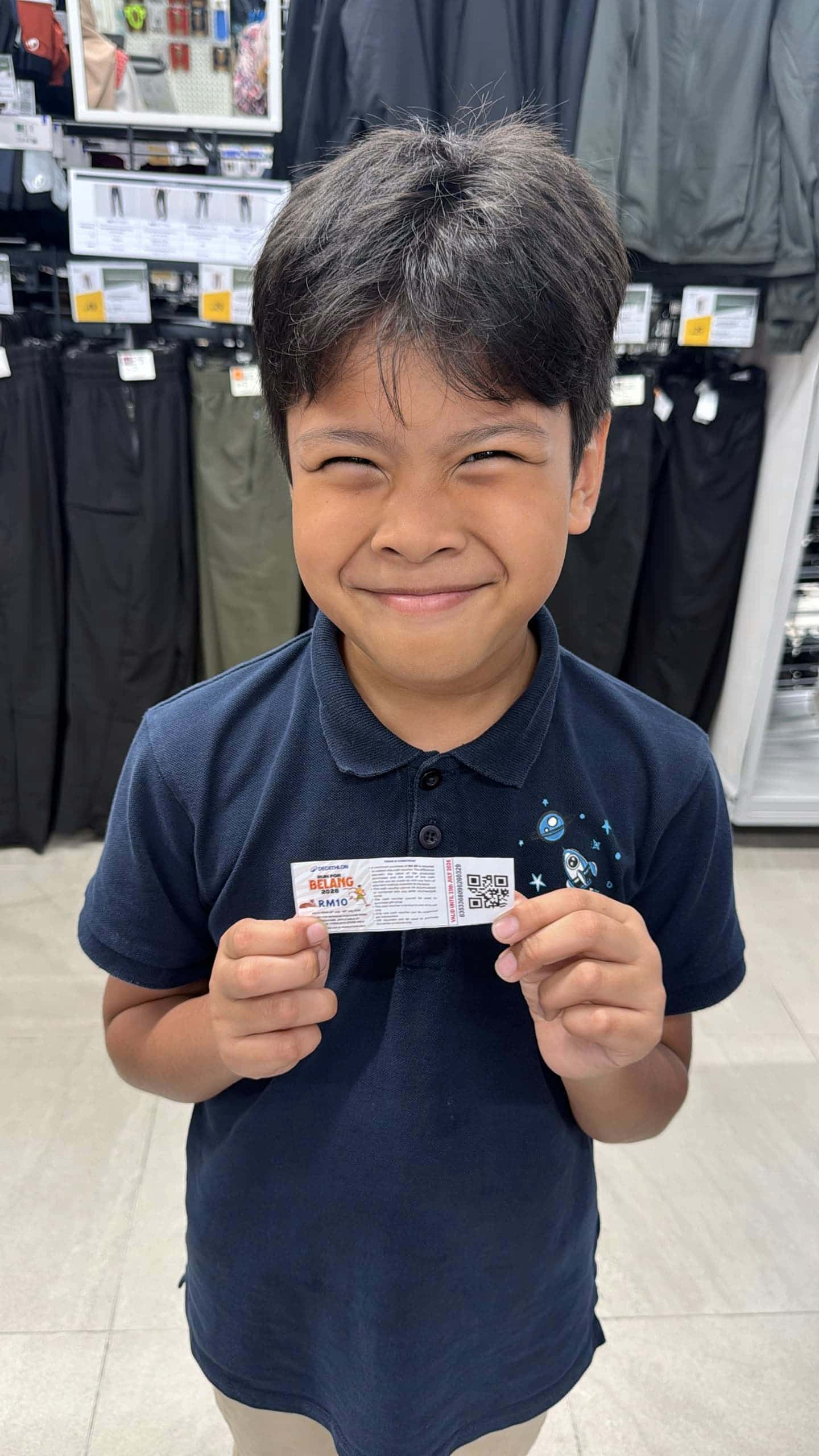 Image from: #GilaBola | Izz Fayyadh won a cash voucher gift at Decathlon Cyberjaya Store's Run for BELANG 2026 to celebrate World Cup